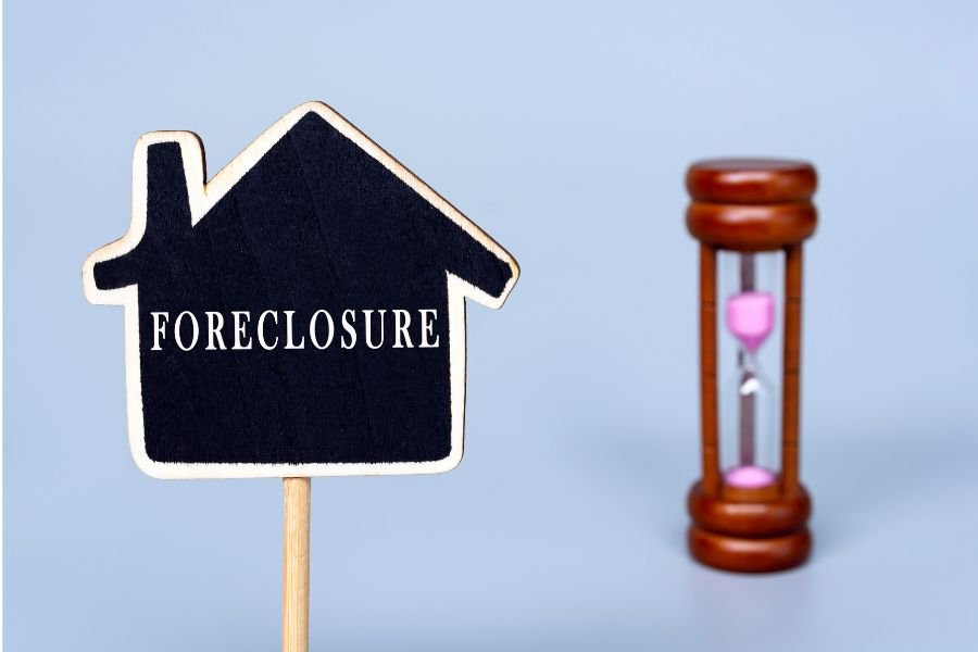 foreclosure sign with an hour glass